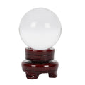 Clear 6cm crystal ball displayed on a wooden base, designed for decorative display and crystal collections.