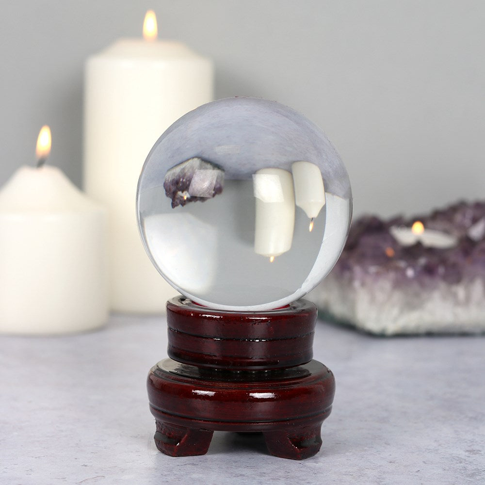 Clear 8cm crystal ball displayed on a wooden stand, designed for decorative display and crystal collections.