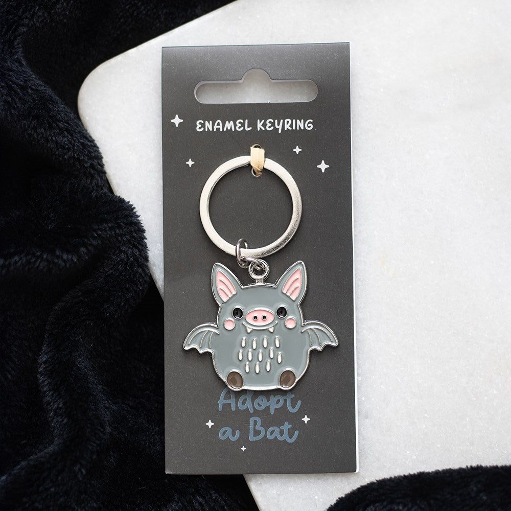 Grey and pink enamel bat charm keyring on a silver split ring, presented on a grey "Adopt a Bat" backing card