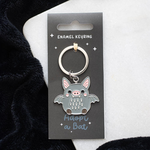 Grey and pink enamel bat charm keyring on a silver split ring, presented on a grey "Adopt a Bat" backing card