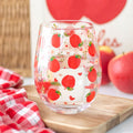 Stemless wine glass featuring decorative apple print pattern with colourful fruit-themed design.