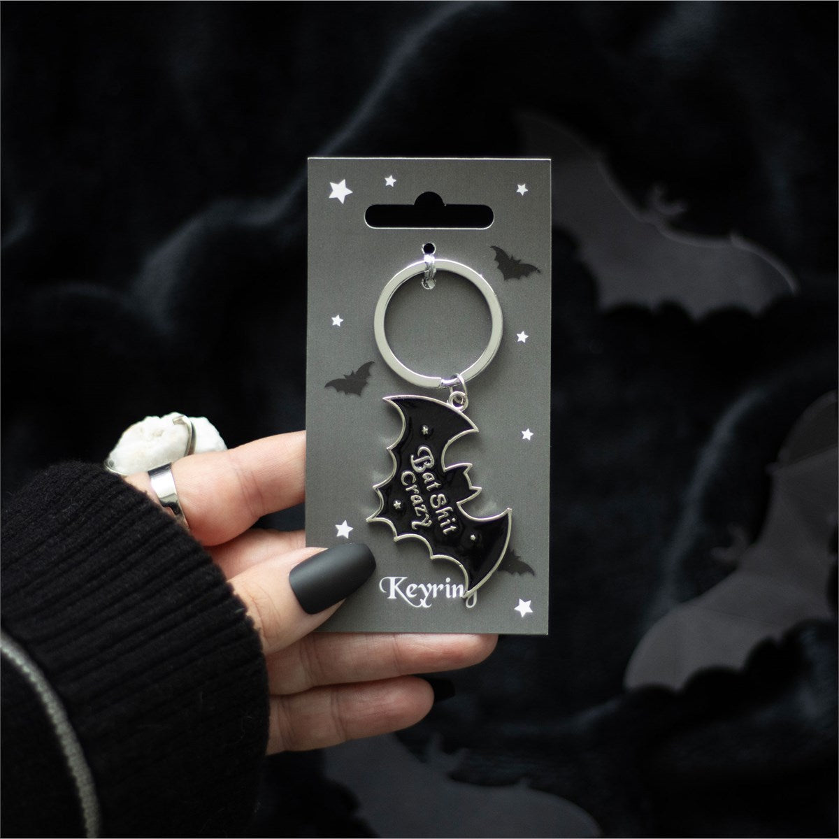 Bat-shaped metal keyring featuring “Bat Sh*t Crazy” text with a gothic-inspired design and attached keyring loop.