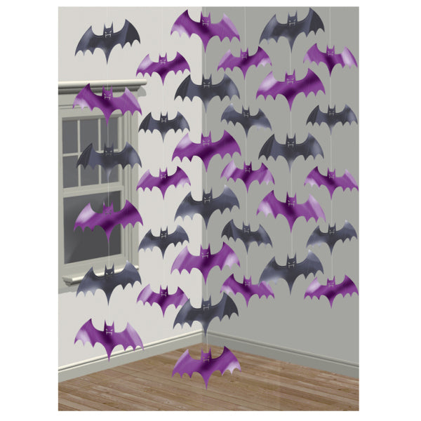 Six foil bat hanging string decorations in black and purple, hung from ceiling to floor against a white wall in a Halloween decorated room