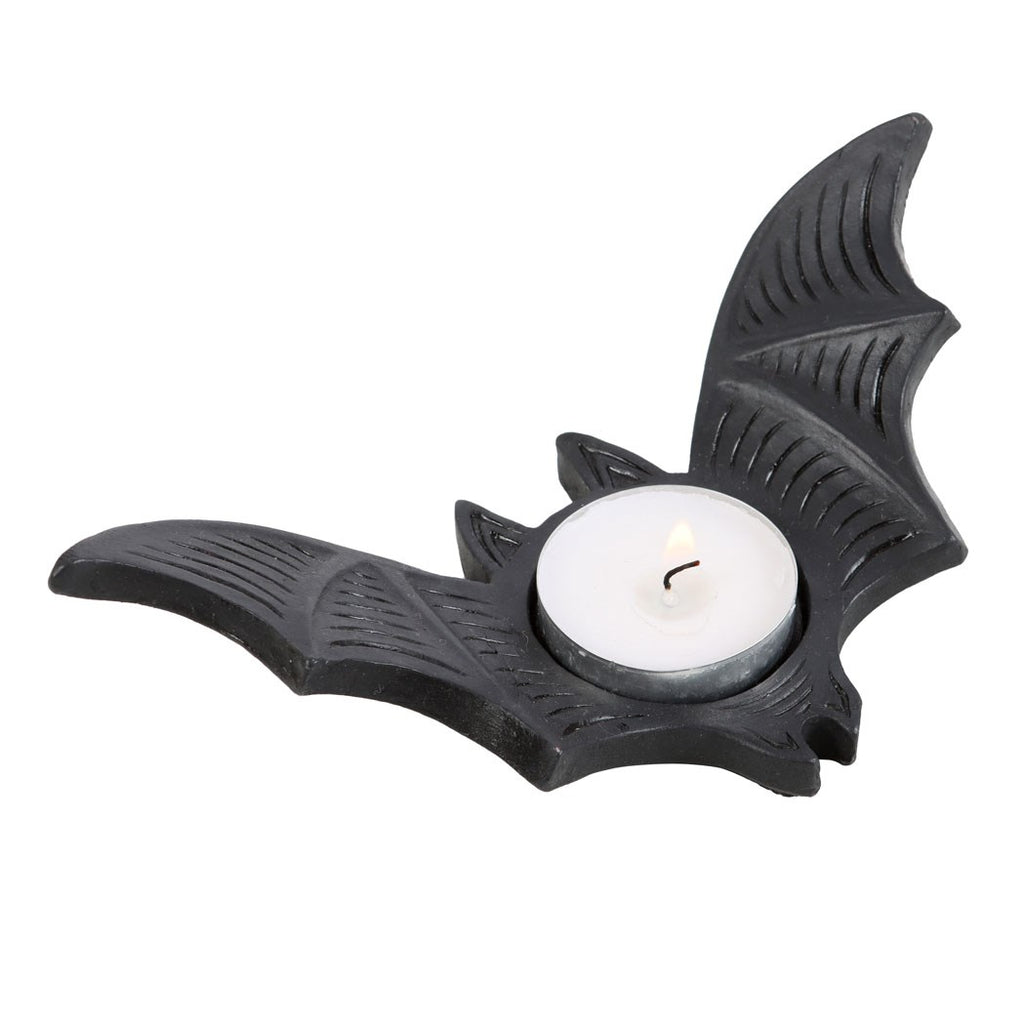 Black bat-shaped tealight candle holder with detailed wing texture, holding a white tealight candle on a white background