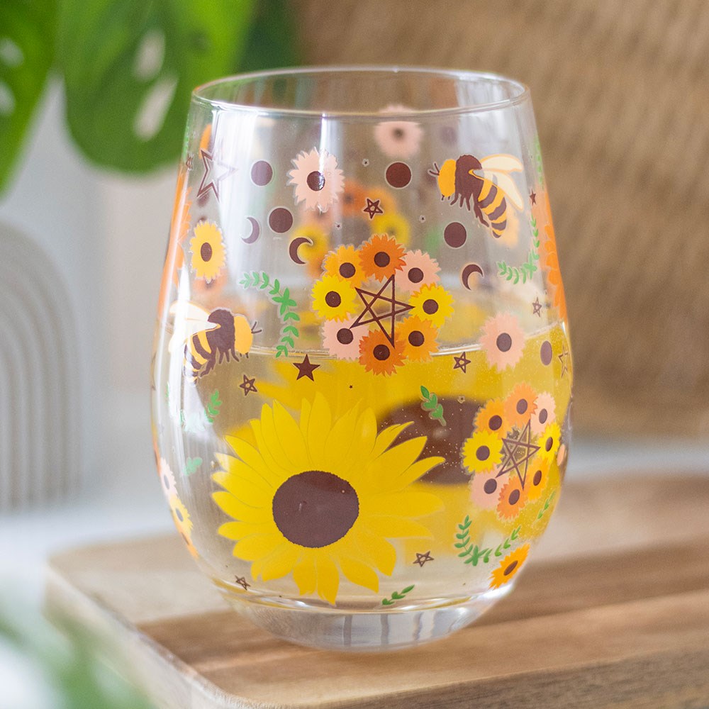 Stemless wine glass featuring Solstice bee themed decorative pattern with nature-inspired artwork.