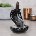Hand and lotus flower backflow incense burner, symbolic design with flowing smoke effect