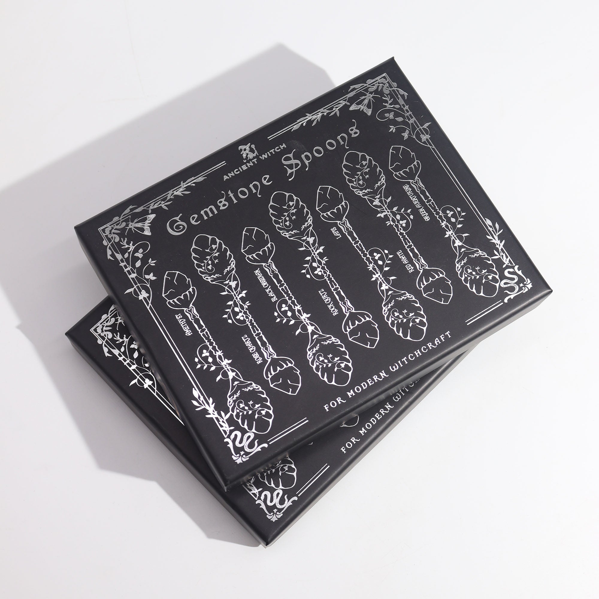 Packaging for 'Gemstone Spoons' with black and white design on a white background