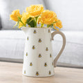 Ceramic flower jug featuring bumble bee print design with decorative floral-inspired detailing and curved handle.