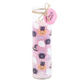 Tall glass tube candy apple scented candle with pastel pink Halloween wrap featuring ghosts, black cats, cauldrons and cobwebs, with a pink circular gift tag and twine bow