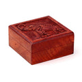 Wooden box with elephant carvings on a white background