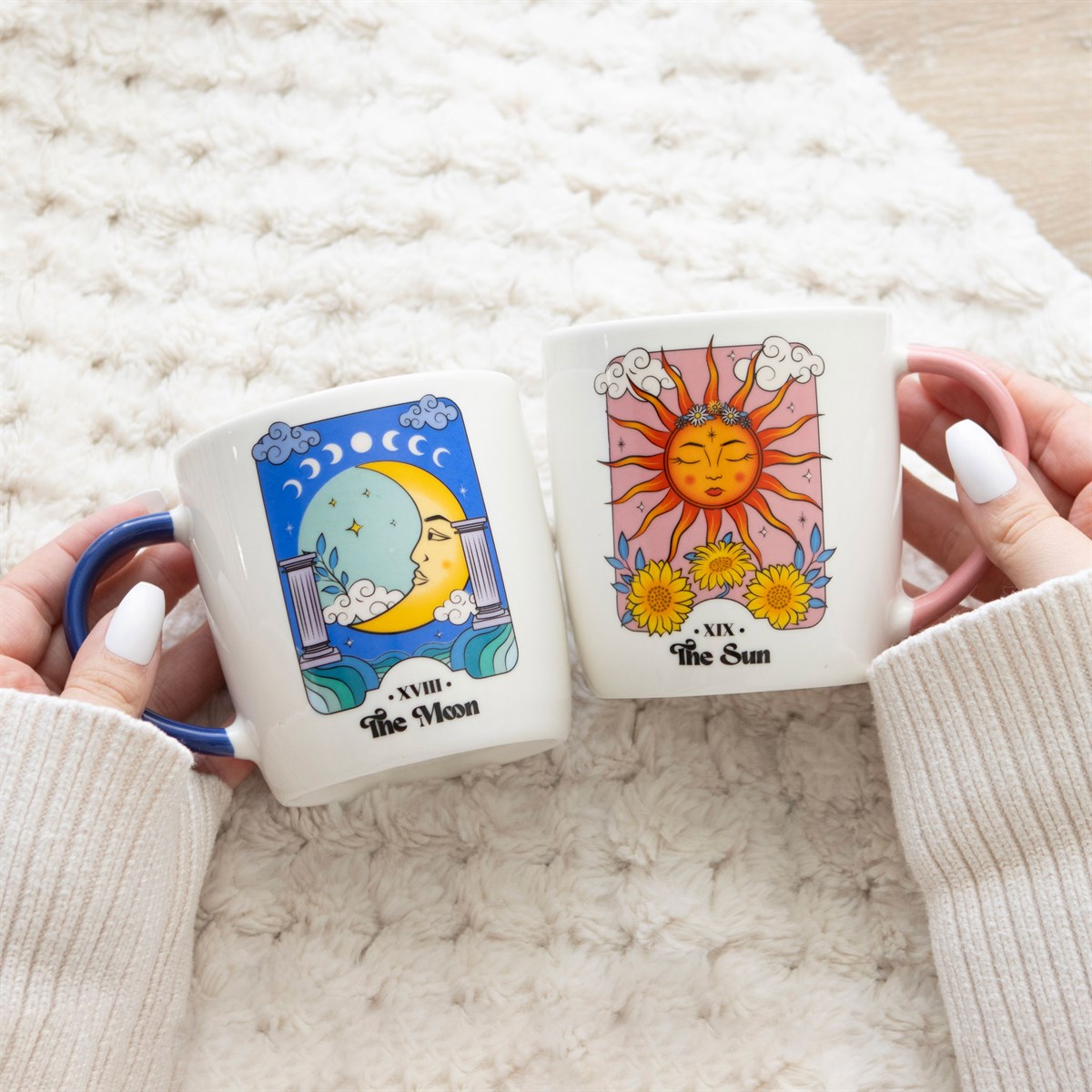 Matching mug set featuring sun and moon celestial designs with decorative cosmic-themed artwork.