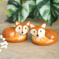 Ceramic salt and pepper pot set shaped like a fox, featuring woodland-inspired detailing, designed for seasoning meals with a cute, decorative touch.