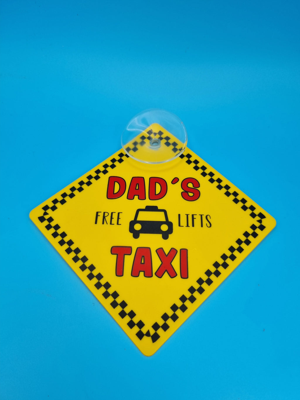 Dad’s Taxi “Free Lifts” suction cup car hanging sign with humorous text for car window display.