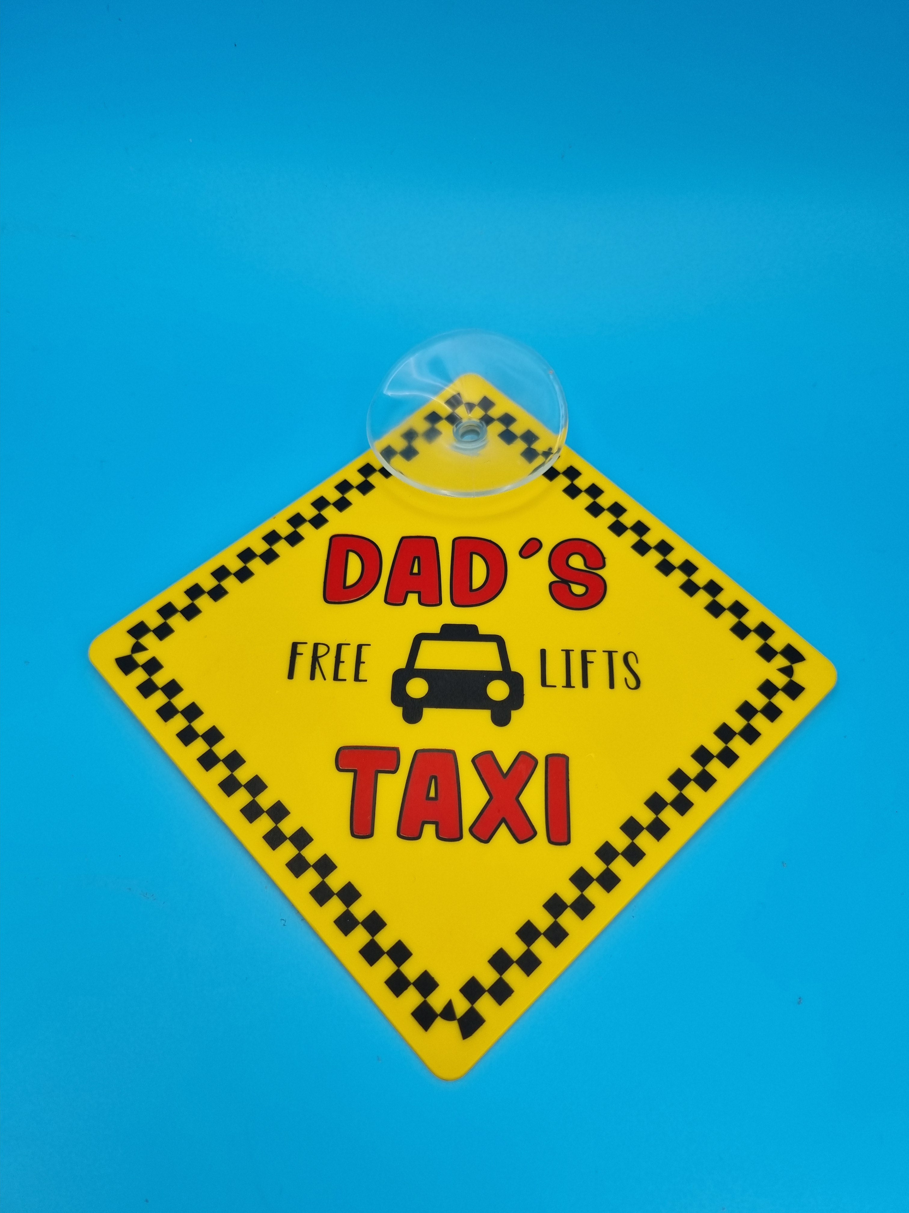 Dad’s Taxi “Free Lifts” suction cup car hanging sign with humorous text for car window display.