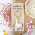 Duck shaped metal and enamel keyring with “Waddle On” text, fun and quirky accessory