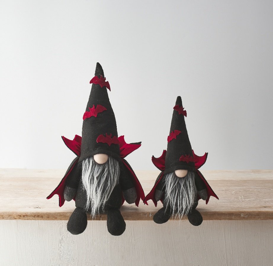 wo Halloween vampire gonks with black pointed witch hats trimmed with red bats and matching red bat capes, sitting side by side on a wooden shelf, large and small sizes shown