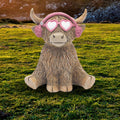 Ear Moofs Highland Cow figurine wearing earmuffs and glasses, novelty resin ornament with cosy winter-themed design