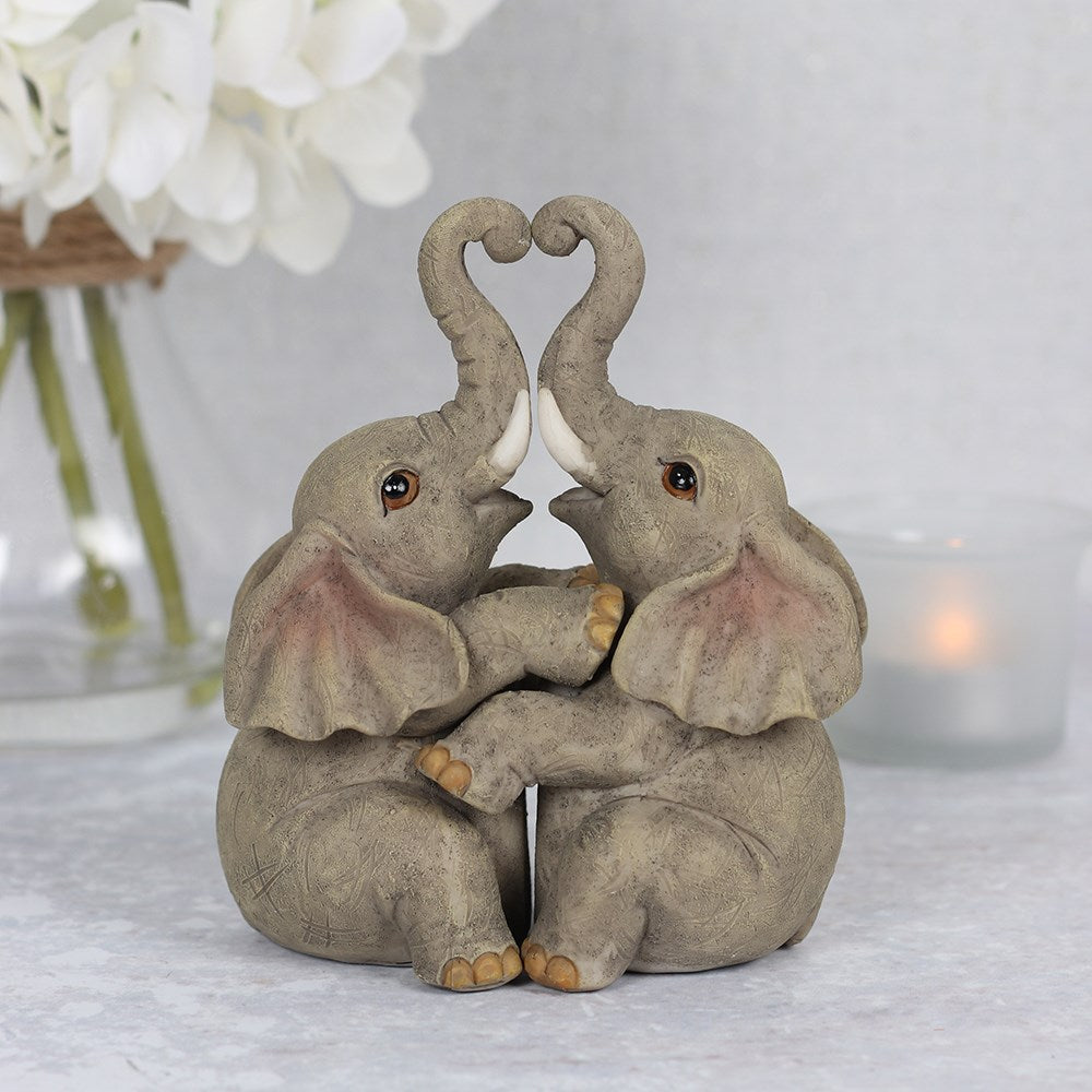 Decorative elephant couple embrace figurines featuring affectionate pose and detailed ornamental finish.
