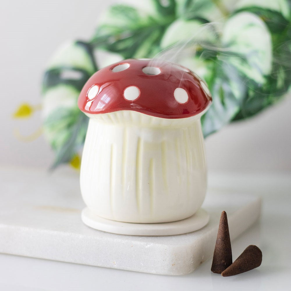 Ceramic mushroom-shaped incense cone burner with whimsical design, gently releasing fragrant smoke—perfect for cozy decor, relaxation, and thoughtful gifting.