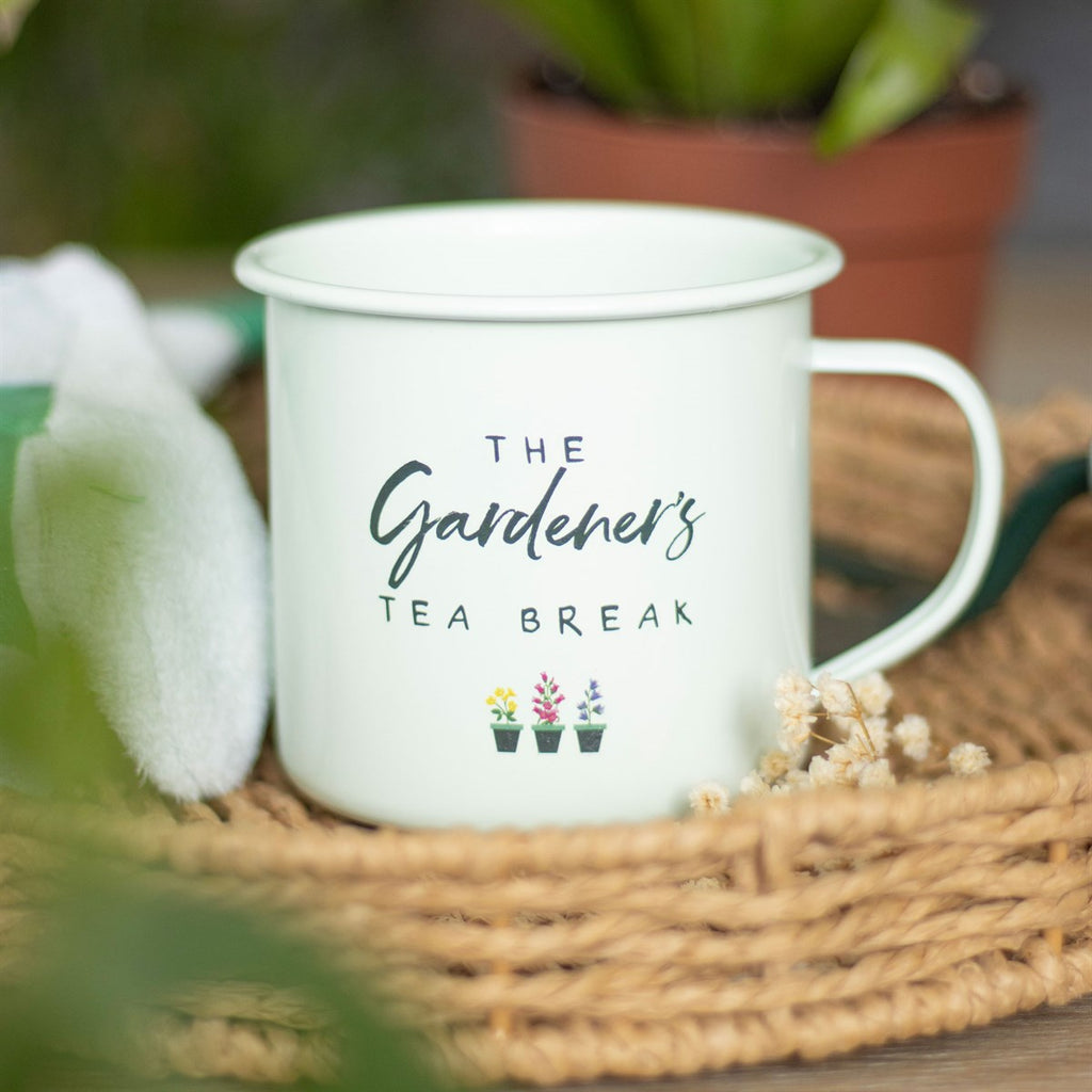 Sage green enamel mug with "The Gardener's Tea Break" text and three colourful flower pot illustrations on a white background