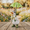 White resin duck figurine with brown pointed hat, flower bouquet and green umbrella, wearing green wellington boots