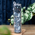 Tall clear glass tube candle with a dark midnight hare and botanical pattern featuring running and sitting hares, crescent moons, and orange and white flowers, tied with a silver ribbon bow and Wild Tulip fragrance tag, displayed on a wooden board