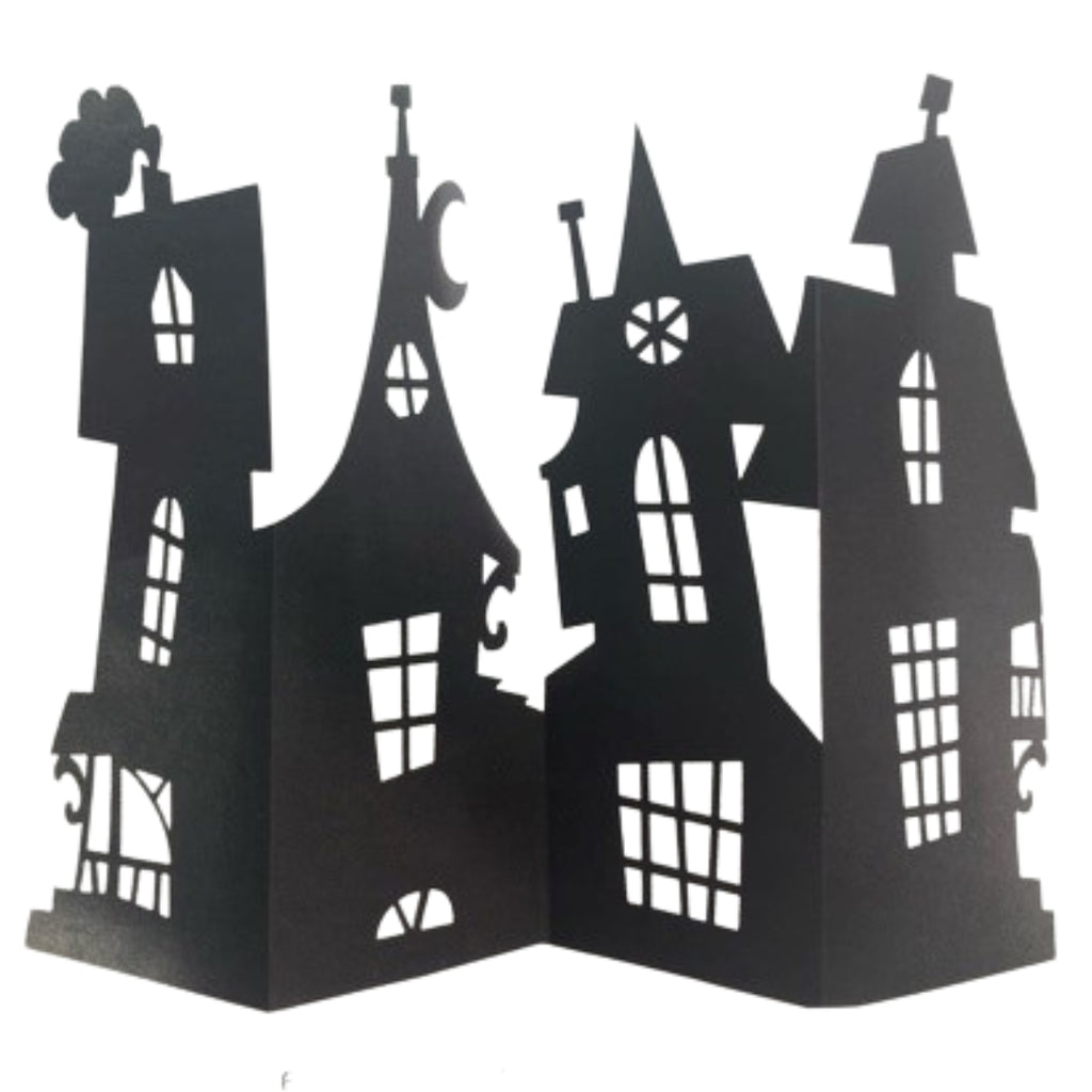 Black cardboard haunted house centrepiece decoration with detailed cut-out windows and spires, standing folded open on a white background
