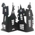 Black cardboard haunted house centrepiece decoration with detailed cut-out windows and spires, standing folded open on a white background