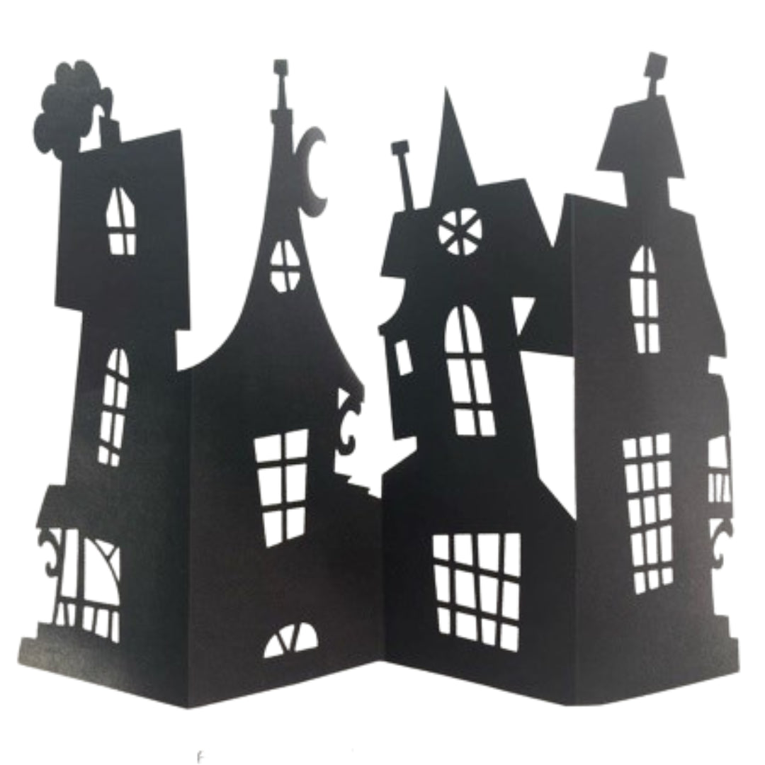 Black cardboard haunted house centrepiece decoration with detailed cut-out windows and spires, standing folded open on a white background
