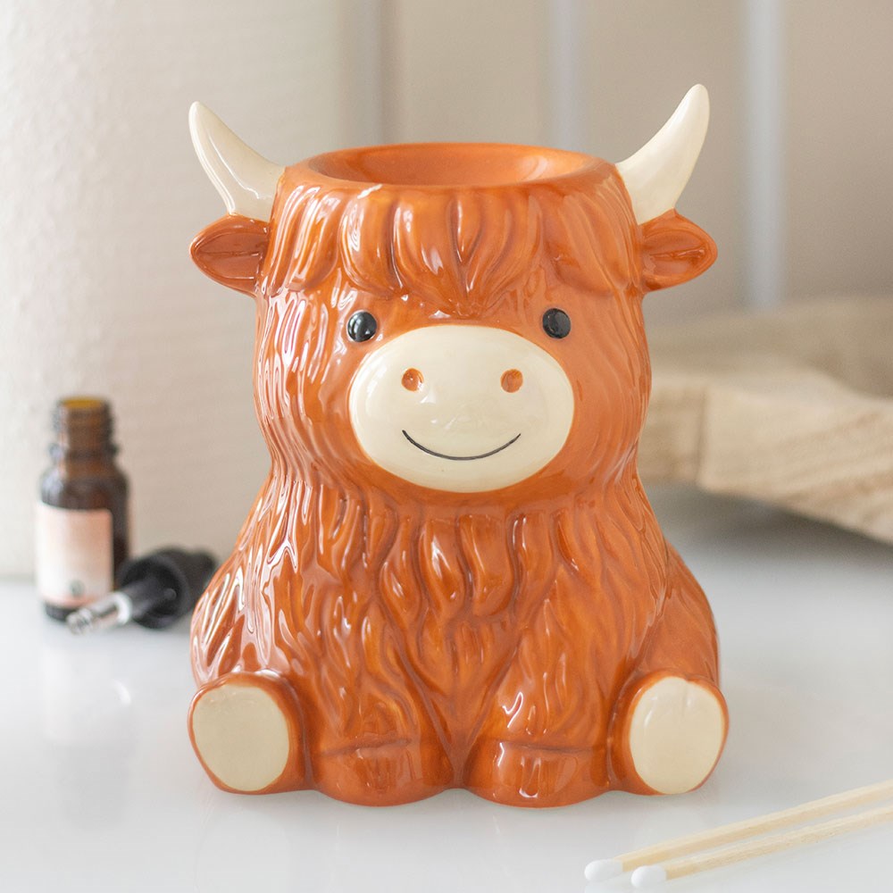 Highland cow shaped ceramic oil burner and wax warmer with rustic countryside-inspired design.