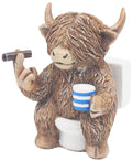 Highland cow figurine sitting on a toilet in a humorous novelty decorative design.