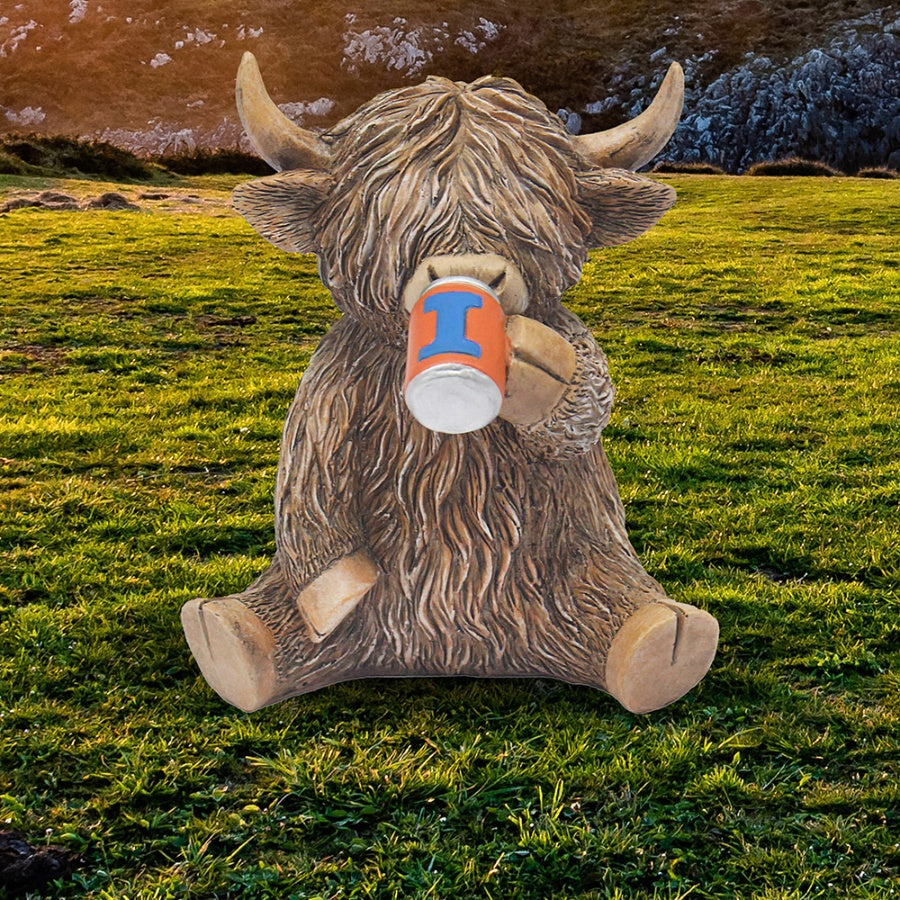 Statue of a Highland cow with a blue and orange Irn Bru can in a grassy field.