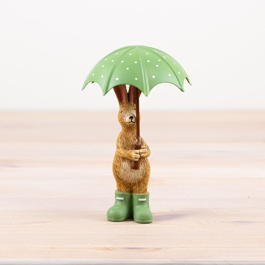 Jasper rabbit holding umbrella figurine, a whimsical ornament with a cosy and playful feel