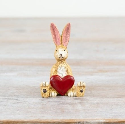Sitting Jasper rabbit with red heart, a cute ornament symbolising love and affection