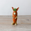 Jasper rabbit figurine wearing a carrot costume, a cute and whimsical decorative ornament for any space