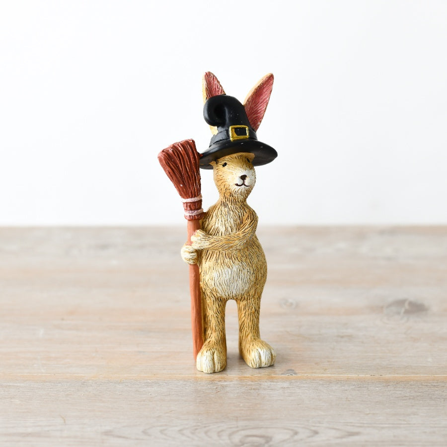 Jasper Rabbit ornament holding a broomstick and wearing a black witch's hat, ideal for Halloween and autumn home décor.
