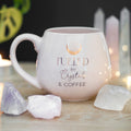 Pale pink rounded ceramic mug featuring the phrase “Fueled By Crystals & Coffee” with crystal, crescent moon and star illustrations.