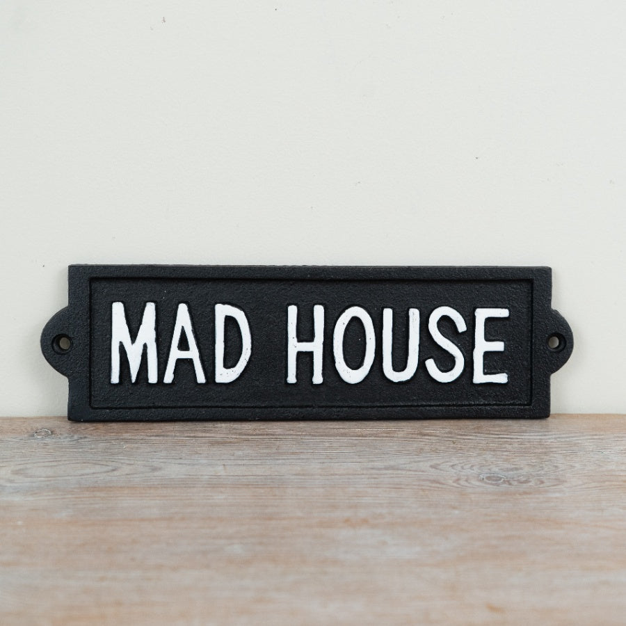 Wall mounted cast iron sign reading “Mad House” with rustic vintage-style humorous decorative design.