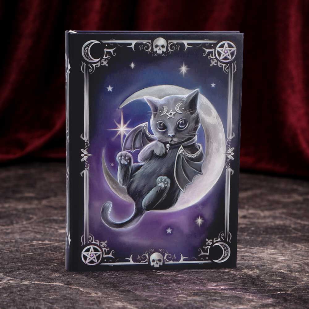 Cult Cuties Malpuss A5 hardback journal — black hardback cover featuring a bat-winged black cat with pentagram forehead markings perched on a crescent moon, purple starry sky background with silver skull and pentagram border details