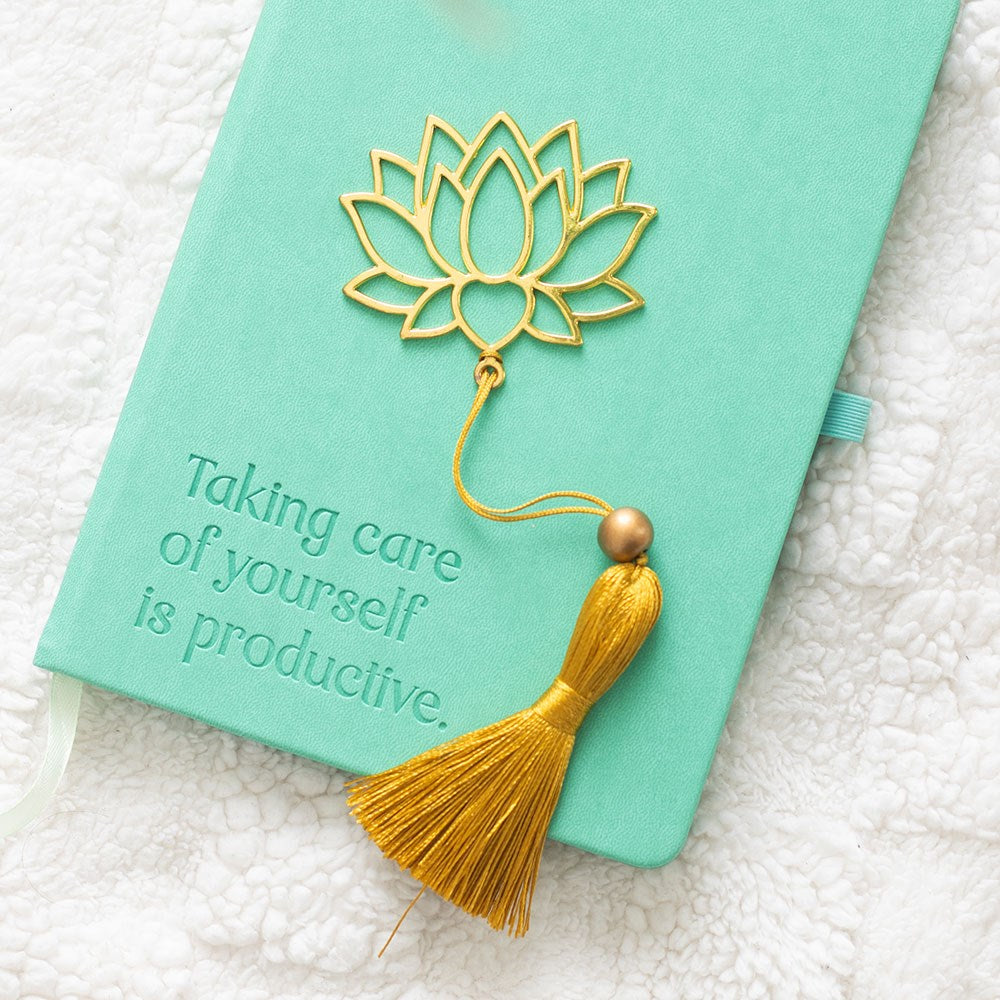 Gold-coloured metal bookmark shaped like a lotus flower with decorative tassel, ideal for marking pages with a touch of elegance and symbolism.