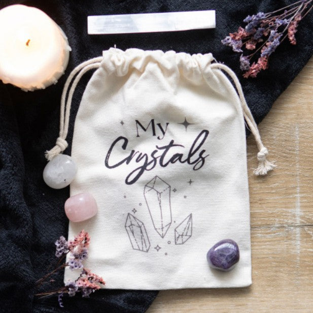 Natural cotton drawstring bag printed with “My Crystals” text, designed for storing crystals, gemstones, and small treasures.