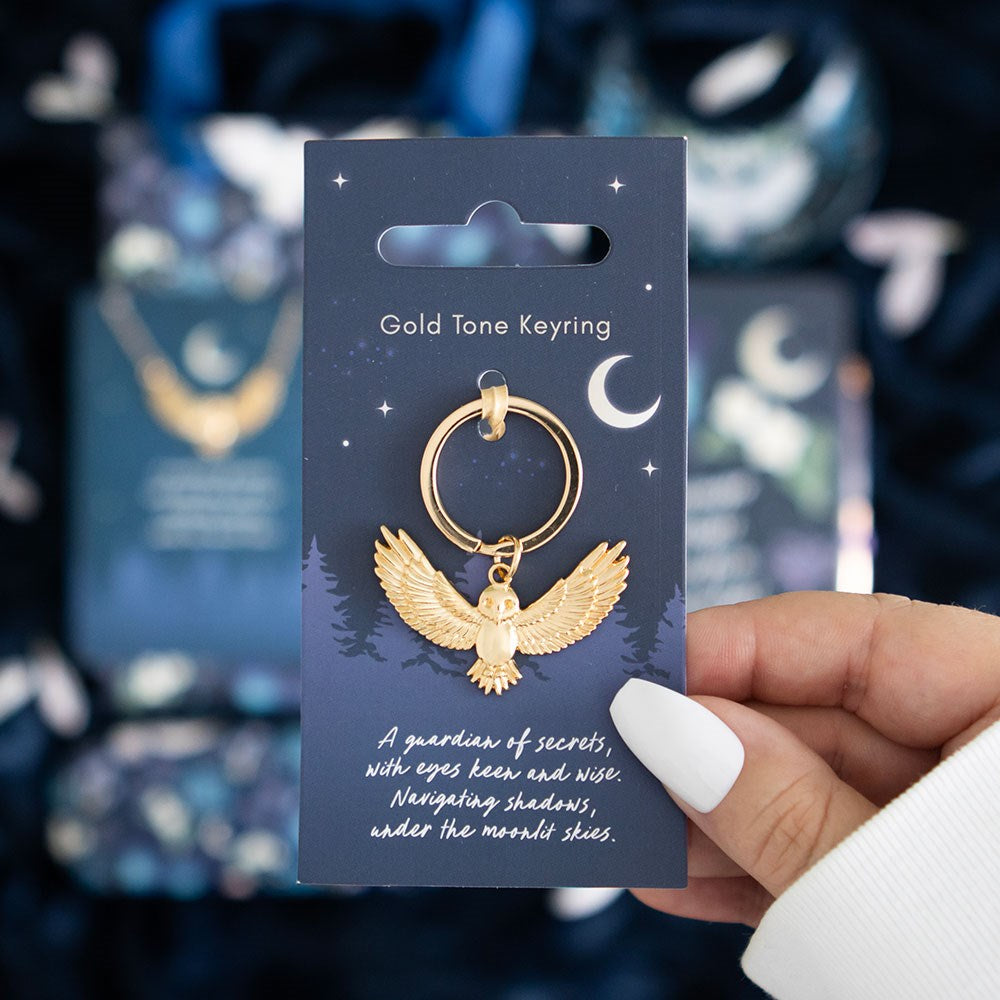 Gold-tone metal keyring featuring a “Night Owl” themed owl charm with decorative detailing and attached keyring loop.