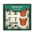 Plant Pot Egg Cup Set gift box containing two terracotta-style ceramic egg cups and two stainless steel garden shovel spoons, with a bug and butterfly illustrated insert