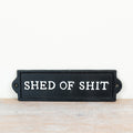 Wall mounted cast iron sign reading “Shed Of Sh*t” with rustic vintage-style humorous decorative design.