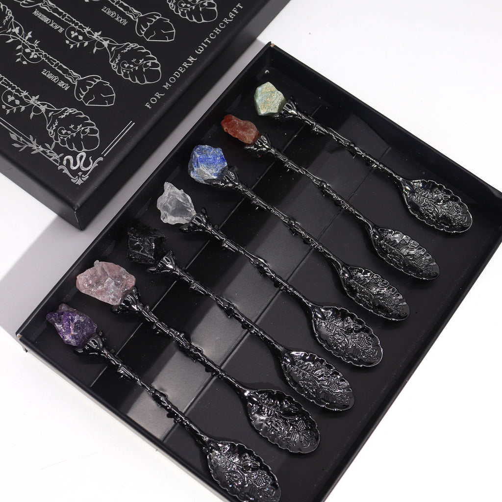 Set of decorative spoons with embedded crystals in a black box
