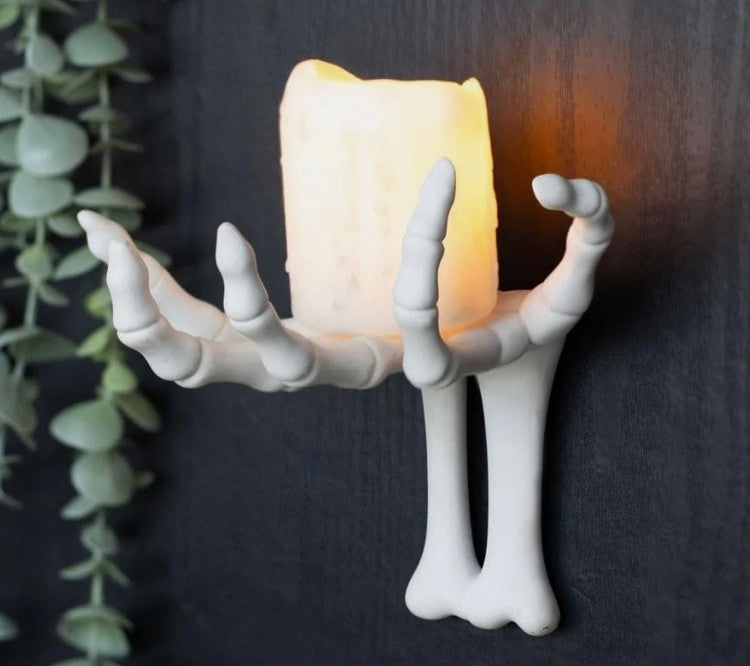 Wall mounted hook shaped like a skeletal hand emerging from the wall, designed for holding keys, jewellery, lightweight decorations, and small accessories.