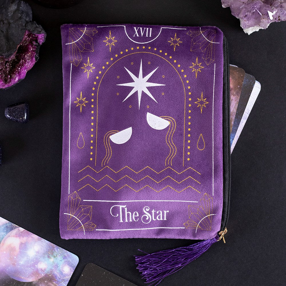 Purple velvet zipper tarot card bag with The Star XVII design, gold foil detailing, white star motif, and purple tassel zip pull, styled with crystals and tarot cards