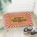 Natural coir door mat featuring “Welcome To The Circus” text with humorous decorative design.