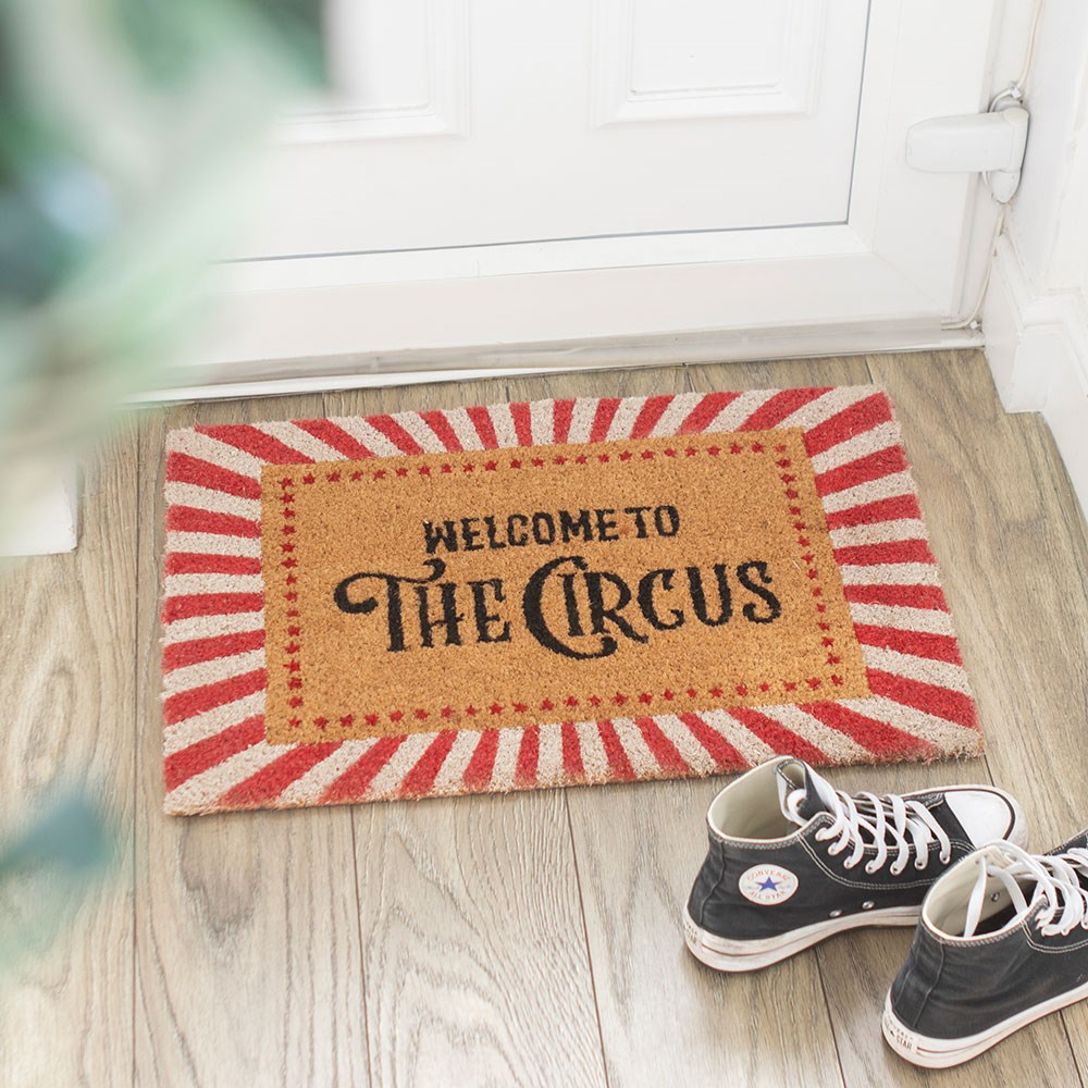 Natural coir door mat featuring “Welcome To The Circus” text with humorous decorative design.