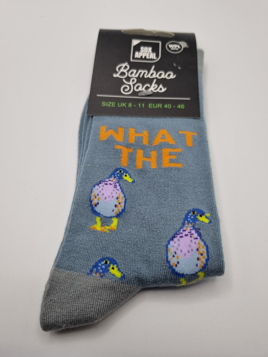 Blue What The Duck novelty men's bamboo socks with orange text and cartoon duck illustrations, grey cuffs and toes, UK size 8–11, shown in packaging